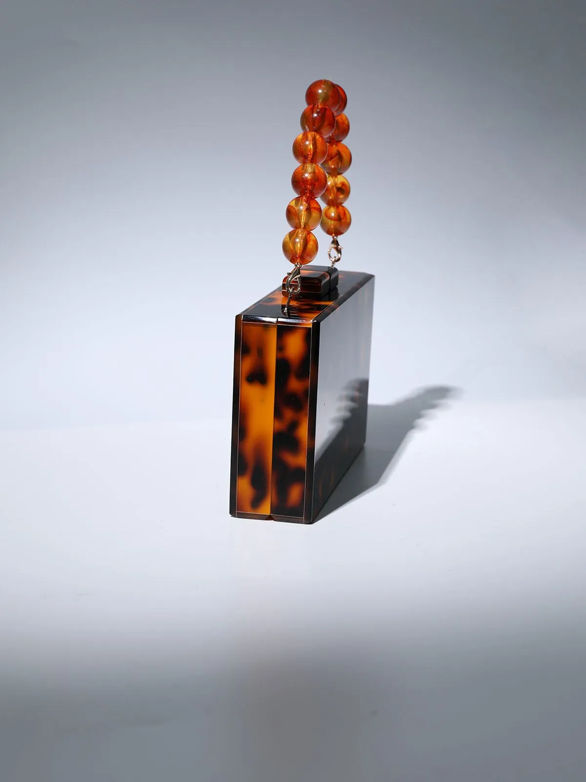 ACRYLIC BEADED CLUTCH IN AMBER Gloria Lanvin